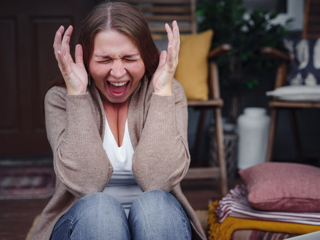 middle aged depressed woman sitting on porch.